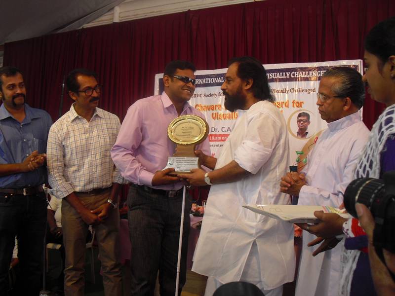 Receiving Chavara Award from Dr. K J Yesudas